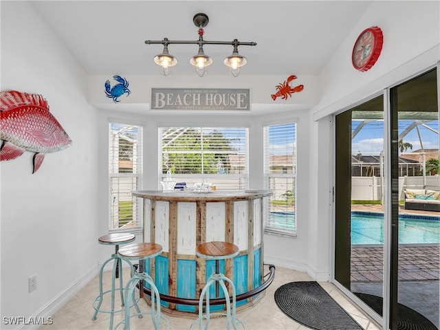 201 SE 4th St, Cape Coral, FL 33990 - dining area featuring baseboards and light tile patterned floors