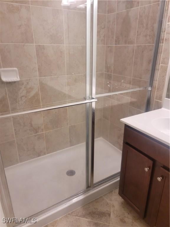 bathroom featuring vanity and a shower stall