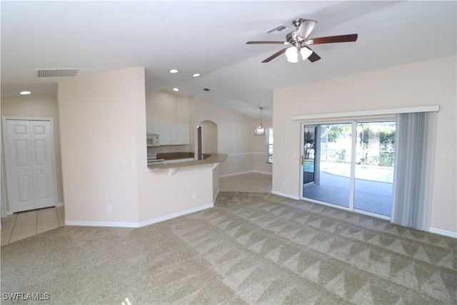 923 SW 35th St, Cape Coral, FL 33914 - unfurnished living room with a ceiling fan, light carpet, visible vents, baseboards, and vaulted ceiling
