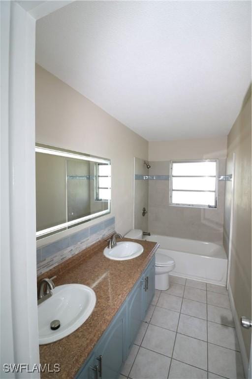 4318 S Pacific Cir, North Fort Myers, FL 33903 - bathroom featuring a sink, tile patterned flooring, toilet, and shower / bath combination