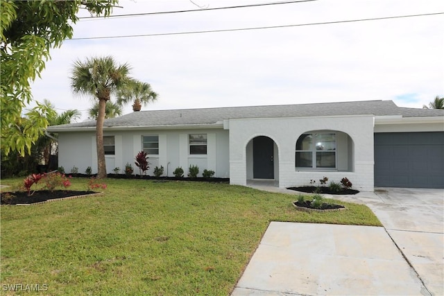 4318 S Pacific Cir, North Fort Myers, FL 33903 - single story home featuring driveway, stucco siding, an attached garage, and a front yard