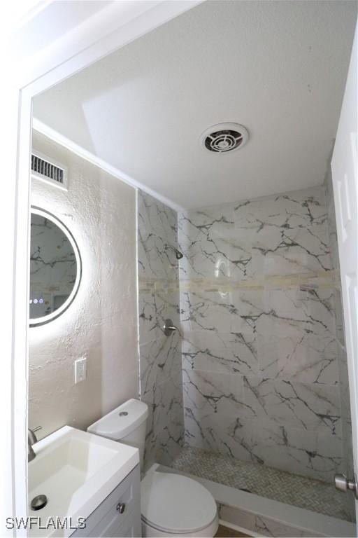 4318 S Pacific Cir, North Fort Myers, FL 33903 - full bathroom with a marble finish shower, visible vents, vanity, and toilet