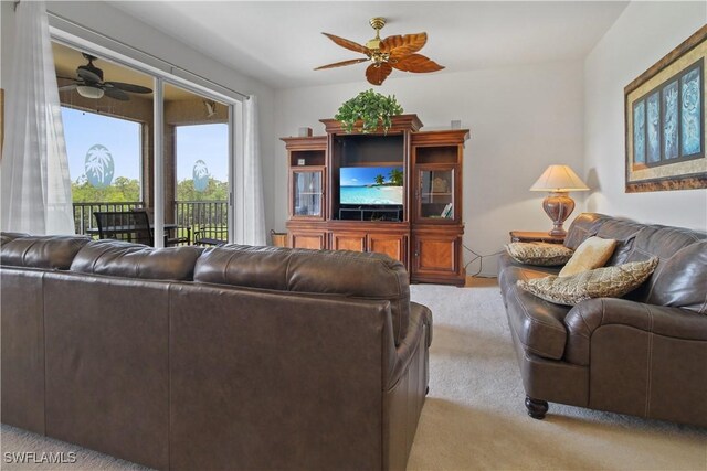 living area with a ceiling fan and light colored carpet