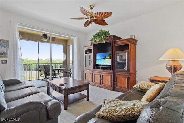 living area featuring carpet and a ceiling fan