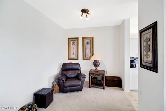 living area with light carpet and light tile patterned flooring