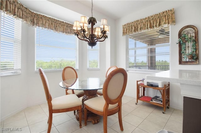 dining space featuring a chandelier, plenty of natural light, baseboards, and lofted ceiling