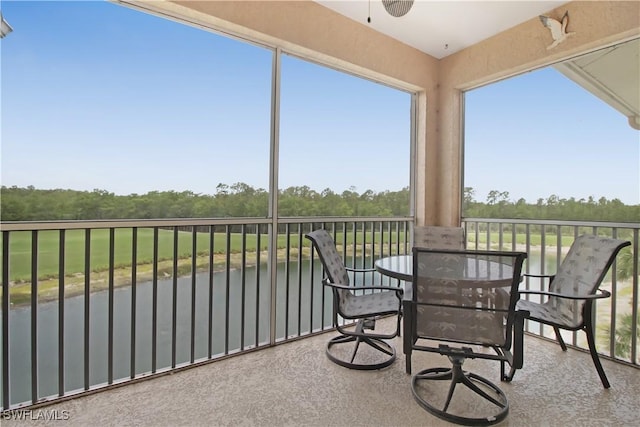 sunroom / solarium with view of wooded area