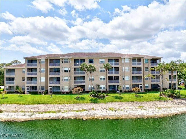 view of apartment building / complex with a water view
