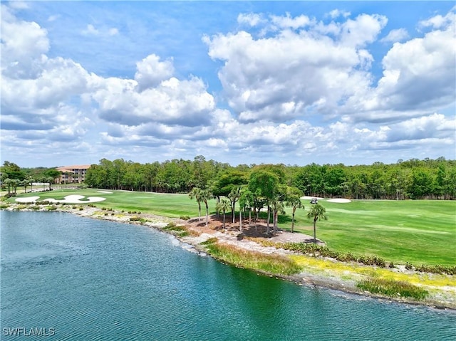 water view featuring a golf club and a tree filled landscape