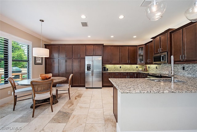 3599 Beaufort Ct, Naples, FL 34119 - kitchen with appliances with stainless steel finishes, dark brown cabinetry, decorative backsplash, light stone countertops, and crown molding