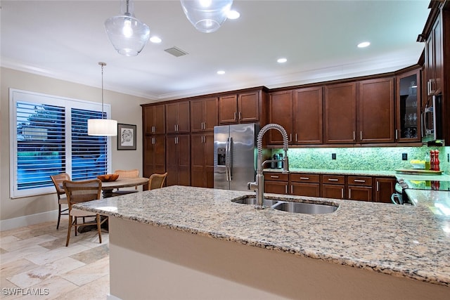 3599 Beaufort Ct, Naples, FL 34119 - kitchen featuring stainless steel appliances, a sink, crown molding, light stone countertops, and hanging light fixtures