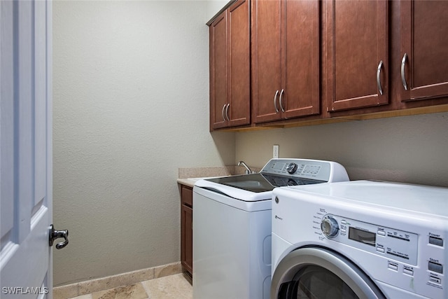3599 Beaufort Ct, Naples, FL 34119 - laundry room with washer and dryer, baseboards, and cabinet space