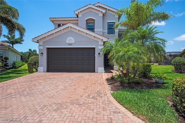 3599 Beaufort Ct, Naples, FL 34119 - mediterranean / spanish home featuring decorative driveway, stucco siding, a front lawn, and a garage