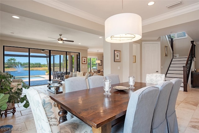 3599 Beaufort Ct, Naples, FL 34119 - dining room featuring recessed lighting, crown molding, stairway, a ceiling fan, and a water view