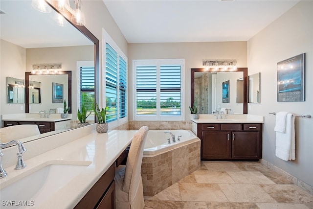 3599 Beaufort Ct, Naples, FL 34119 - bathroom with a bath, two vanities, stone finish floors, and baseboards