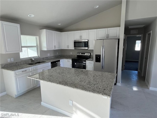 4334 SW 9th Pl, Cape Coral, FL 33914 - kitchen with a sink, stainless steel appliances, light stone counters, vaulted ceiling, and white cabinetry
