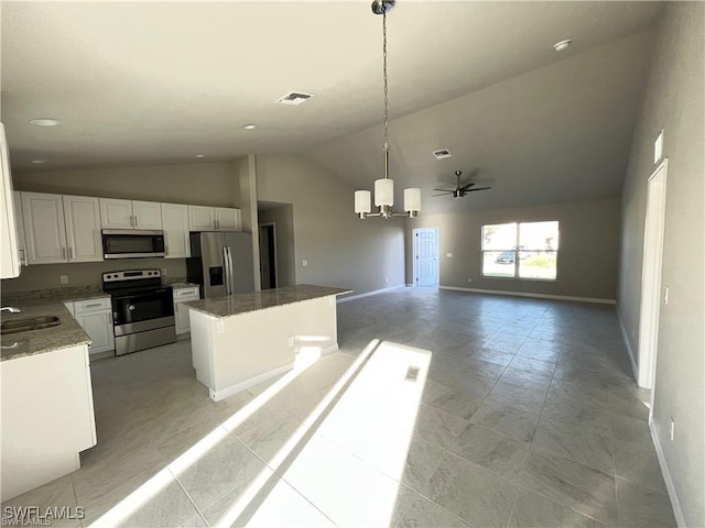 4334 SW 9th Pl, Cape Coral, FL 33914 - kitchen with a notable chandelier, white cabinetry, baseboards, appliances with stainless steel finishes, and a kitchen island