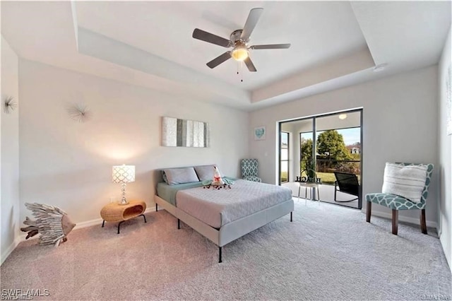 4334 SW 9th Pl, Cape Coral, FL 33914 - bedroom featuring a ceiling fan, a tray ceiling, baseboards, access to outside, and carpet floors
