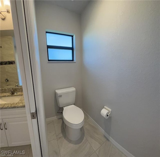 4334 SW 9th Pl, Cape Coral, FL 33914 - bathroom featuring vanity, toilet, and baseboards