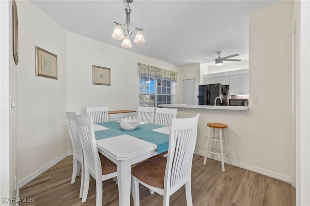 22748 Island Pines Way Unit 102, Fort Myers Beach, FL 33931 - dining room featuring light wood-style flooring, baseboards, and a ceiling fan