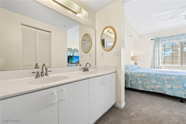 ensuite bathroom with double vanity and carpet