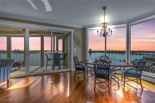 4137 Bay Beach Ln Unit 585, Fort Myers Beach, FL 33931 - dining room featuring crown molding, a wealth of natural light, a water view, and a notable chandelier