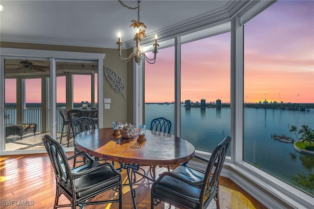 4137 Bay Beach Ln Unit 585, Fort Myers Beach, FL 33931 - dining space with a water view, ornamental molding, hardwood / wood-style floors, and ceiling fan with notable chandelier