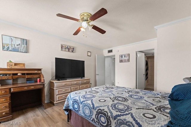 bedroom with light wood finished floors, ornamental molding, and a ceiling fan