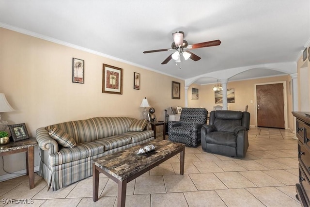 living room featuring arched walkways, ornate columns, a ceiling fan, ornamental molding, and light tile patterned flooring