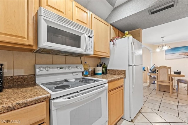 kitchen with white appliances, light brown cabinetry, light tile patterned floors, and decorative light fixtures