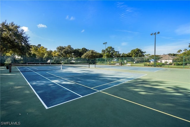 view of tennis court featuring fence