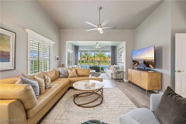 living room with wood finished floors and a ceiling fan