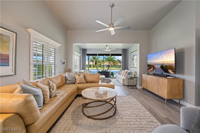 living area with wood finished floors and a ceiling fan