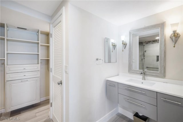 17080 Harbour Point Dr Unit 12B, Fort Myers, FL 33908 - full bath with walk in shower, a closet, baseboards, wood finished floors, and vanity