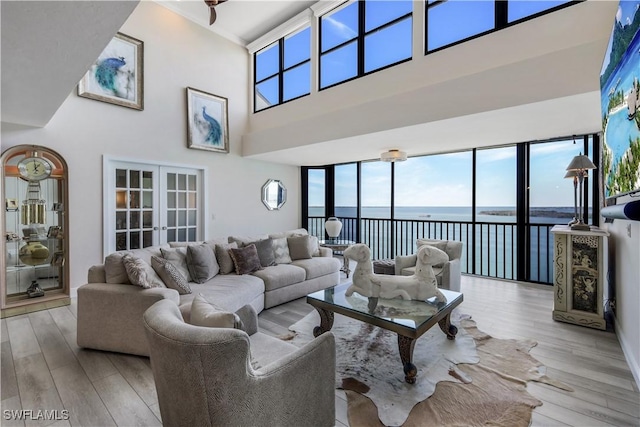 17080 Harbour Point Dr Unit 12B, Fort Myers, FL 33908 - living room with a water view, a high ceiling, wood finished floors, and french doors