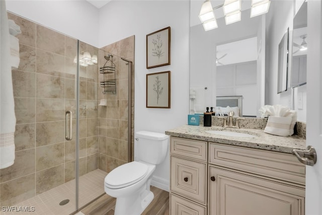 28009 Foxrock Ct, Bonita Springs, FL 34135 - full bath with vanity, toilet, a shower stall, and wood finished floors