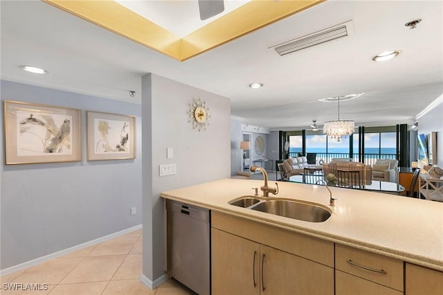 100 N Collier Blvd Unit 507, Marco Island, FL 34145 - kitchen featuring stainless steel dishwasher, a sink, open floor plan, light countertops, and baseboards