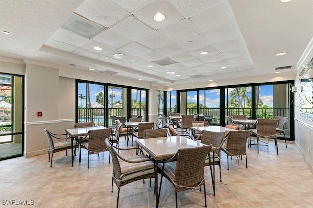 100 N Collier Blvd Unit 507, Marco Island, FL 34145 - dining room featuring light tile patterned floors, baseboards, and a drop ceiling