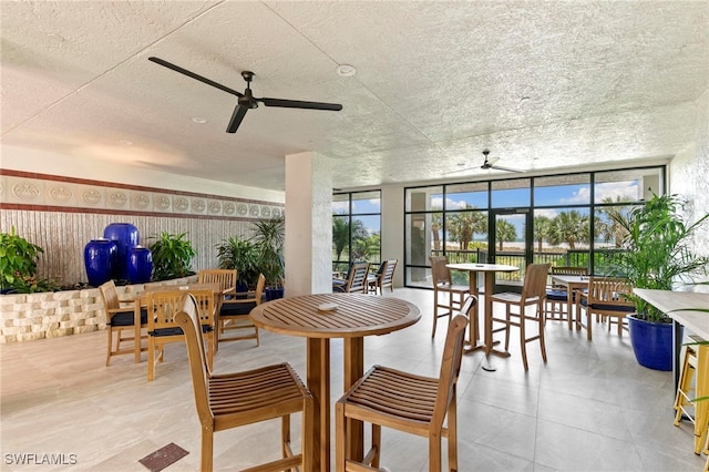 100 N Collier Blvd Unit 507, Marco Island, FL 34145 - dining room featuring a ceiling fan, floor to ceiling windows, and tile patterned floors