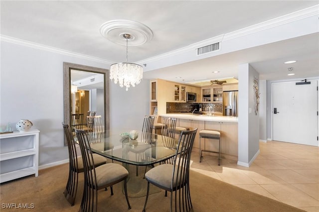 100 N Collier Blvd Unit 507, Marco Island, FL 34145 - dining room featuring baseboards, crown molding, light tile patterned floors, and a chandelier