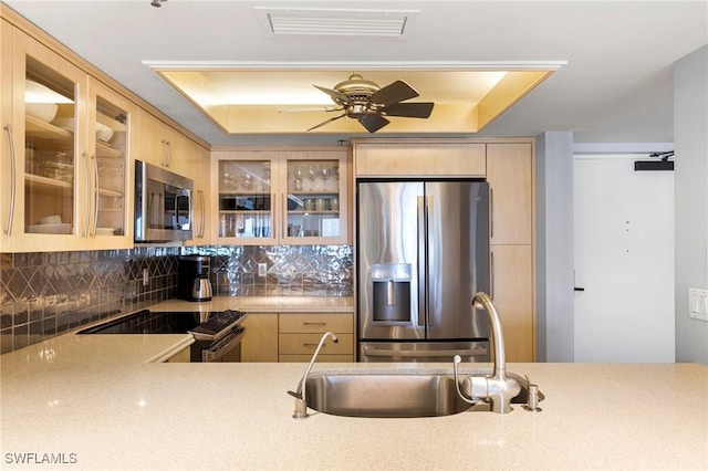 100 N Collier Blvd Unit 507, Marco Island, FL 34145 - kitchen featuring stainless steel appliances, light brown cabinets, and tasteful backsplash