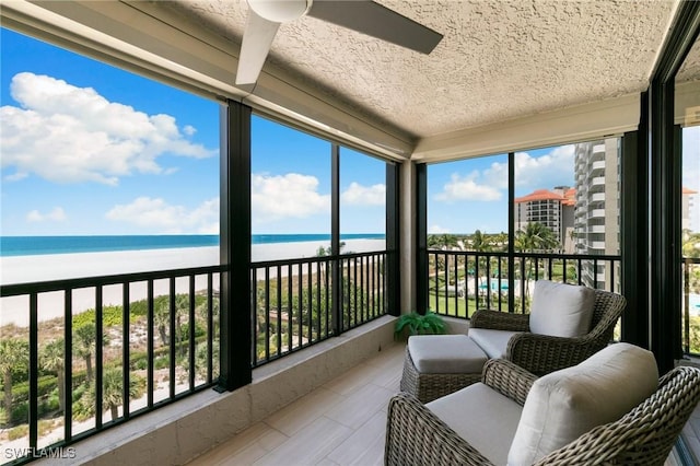 100 N Collier Blvd Unit 507, Marco Island, FL 34145 - sunroom / solarium with view of water and beach, ceiling fan, and a textured ceiling