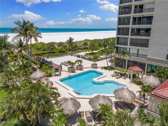 100 N Collier Blvd Unit 507, Marco Island, FL 34145 - community pool with view of water and beach and a patio area