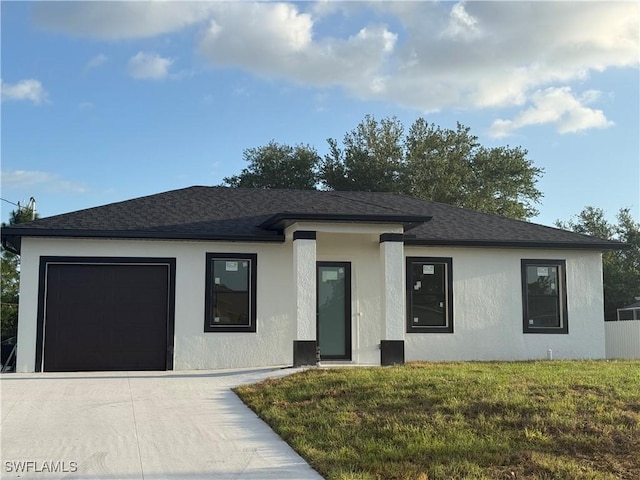 823 Porter St E, Lehigh Acres, FL 33974 - prairie-style home featuring roof with shingles, driveway, a garage, stucco siding, and a front lawn