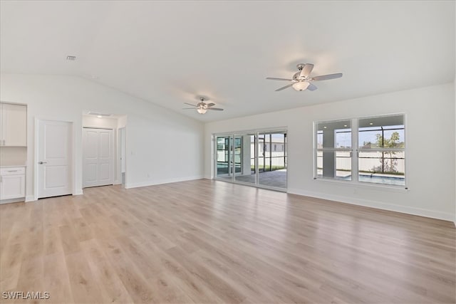 unfurnished living room featuring light wood finished floors, a ceiling fan, baseboards, and lofted ceiling