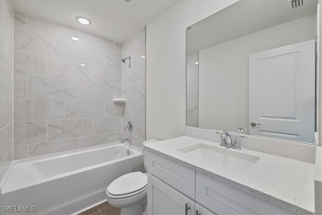 bathroom featuring toilet,  shower combination, visible vents, vanity, and wood finished floors