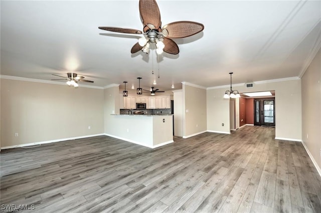 1910 Virginia Ave Unit 1302, Fort Myers, FL 33901 - unfurnished living room featuring ceiling fan, wood finished floors, baseboards, crown molding, and a chandelier