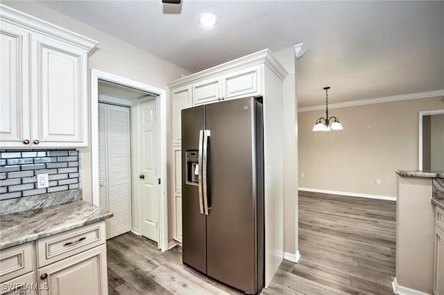 1910 Virginia Ave Unit 1302, Fort Myers, FL 33901 - kitchen with stainless steel refrigerator with ice dispenser, decorative backsplash, a chandelier, baseboards, and light wood finished floors