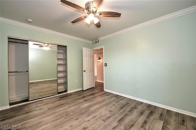 1910 Virginia Ave Unit 1302, Fort Myers, FL 33901 - unfurnished bedroom featuring wood finished floors, ornamental molding, a closet, baseboards, and ceiling fan