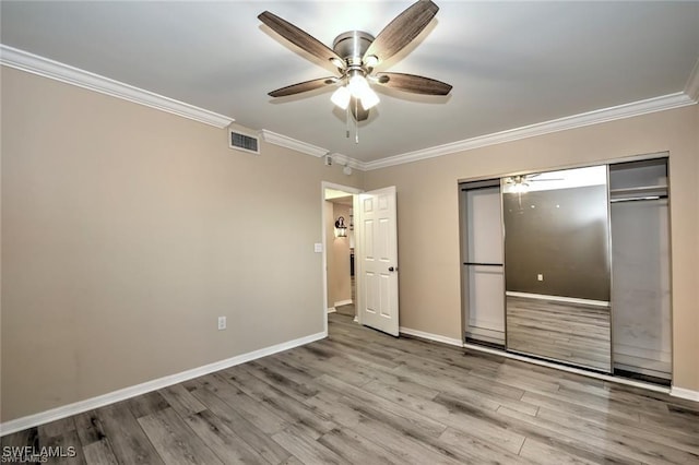 1910 Virginia Ave Unit 1302, Fort Myers, FL 33901 - unfurnished bedroom featuring ornamental molding, wood finished floors, baseboards, a closet, and ceiling fan